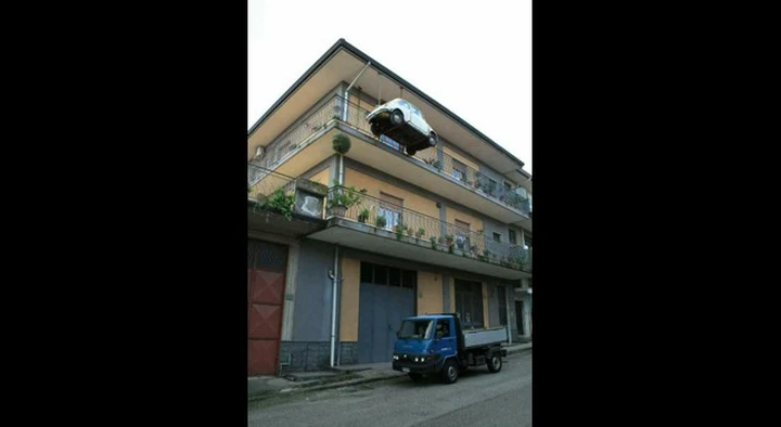 L’auto è senza assicurazione: per non farsela portare via, la appende fuori casa!